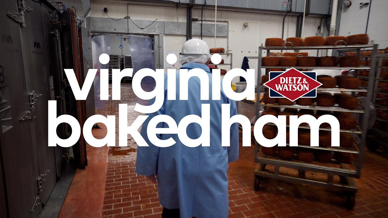 Dietz CEO, Louis, explains the virginia ham baking process while the Dietz team dry rubs the virginia hams.